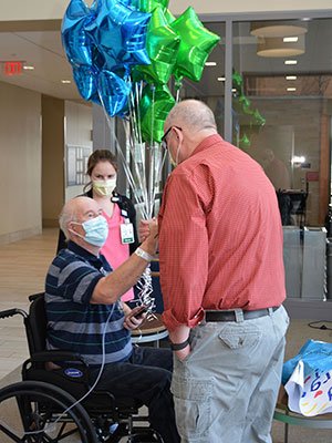 COVID-19 patient Andrew Hisler prepares to leave the Alfond Center for Health