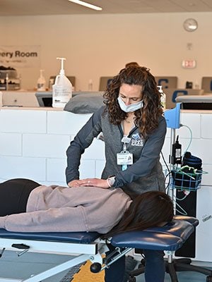 MaineGeneral physical therapist Rachel Ratke works with Colby student Bray Hunter