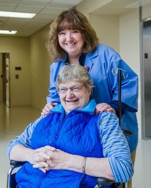 A volunteer assists a patient through MaineGeneral's Hospital Elder Life Program (HELP)